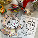 Gordon & Li Li Year of the Fire Horse Puppet Craft, crayons, scissors, and a plush toy on a marble surface.